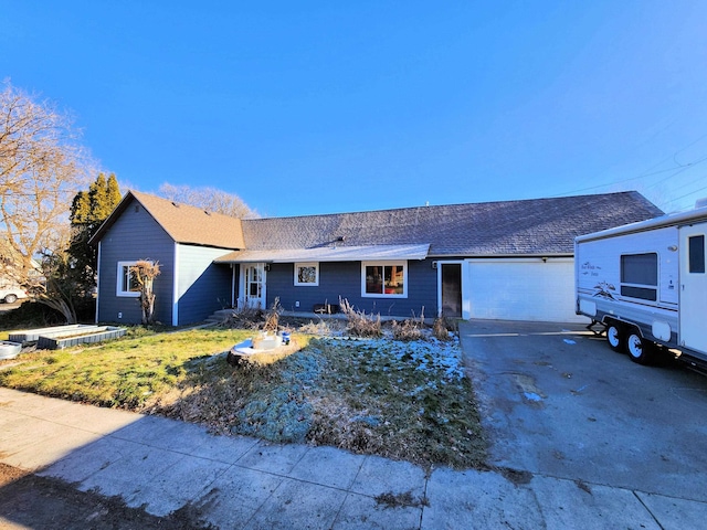 single story home featuring a front lawn and a garage