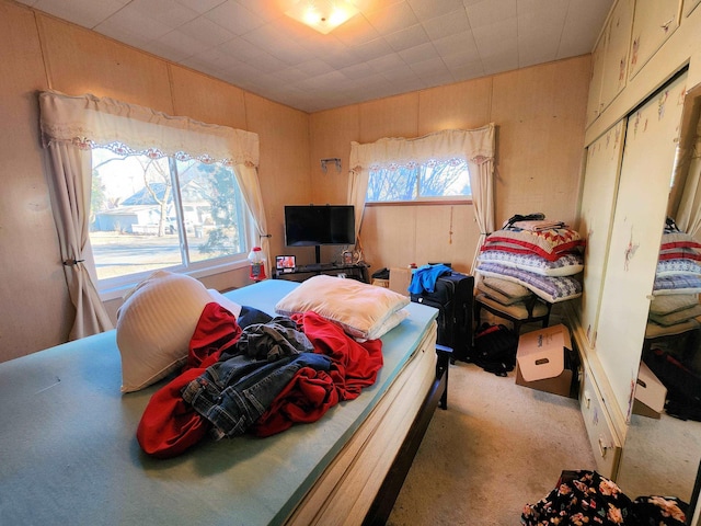 bedroom with light colored carpet and a closet