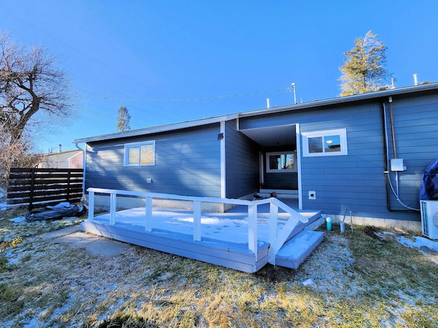 rear view of property featuring a deck