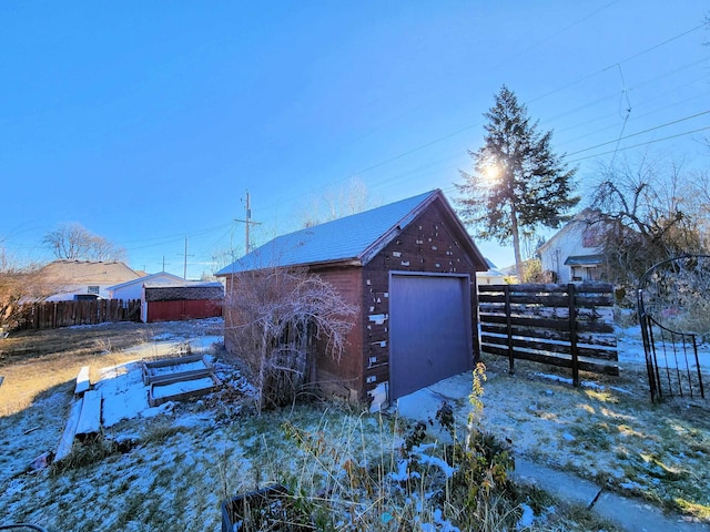 snow covered structure with a garage