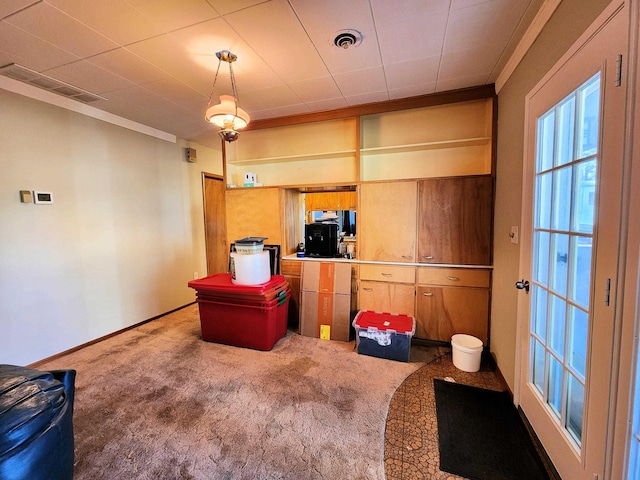 kitchen featuring carpet, ornamental molding, and kitchen peninsula