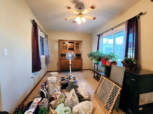 misc room with ceiling fan and light colored carpet