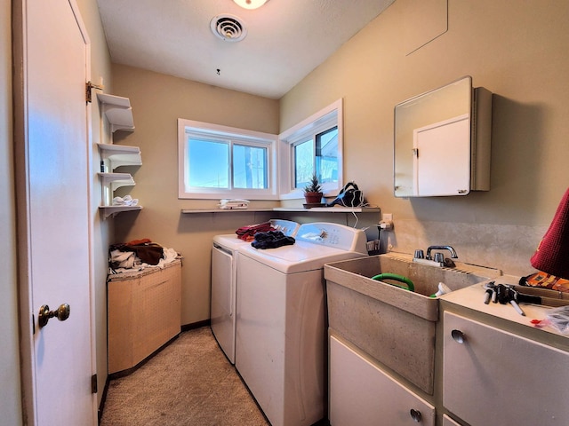 washroom with washer and dryer and cabinets