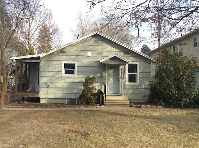 bungalow-style house with a front lawn