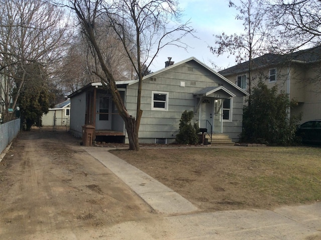 bungalow-style house with a front lawn