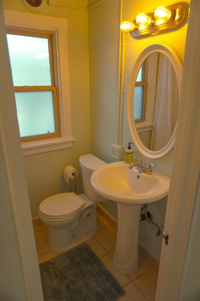 bathroom featuring tile patterned floors and toilet