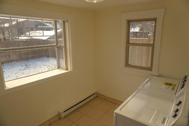 laundry area with light tile patterned floors, baseboard heating, and plenty of natural light