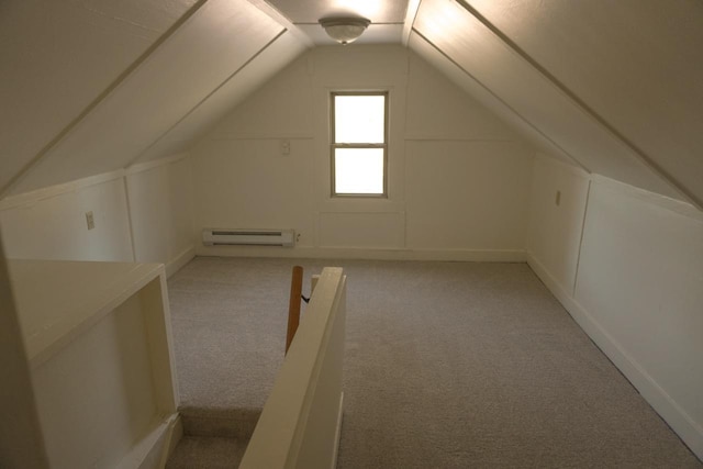 additional living space featuring vaulted ceiling, baseboard heating, and light carpet