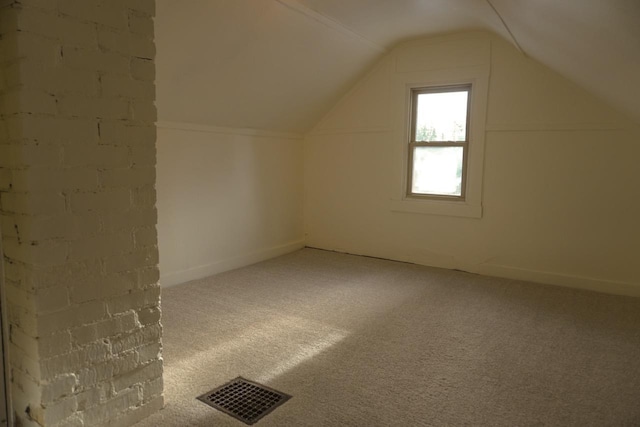 bonus room with lofted ceiling and carpet