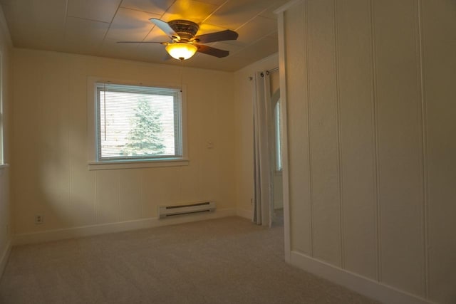 spare room featuring light carpet, baseboard heating, and ceiling fan