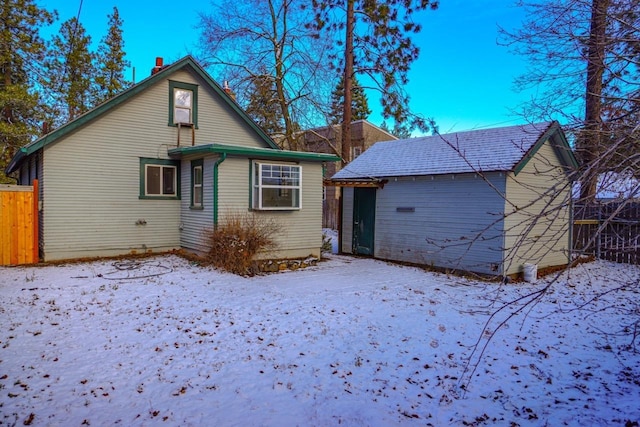 view of snow covered back of property