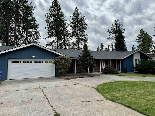 single story home featuring a garage and a front lawn