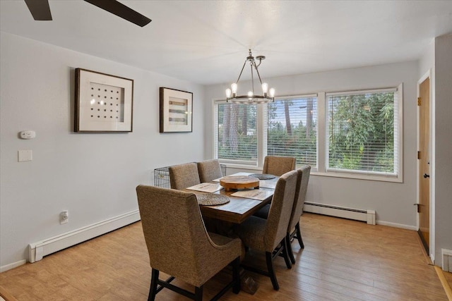 dining area with light hardwood / wood-style floors, a baseboard radiator, and an inviting chandelier