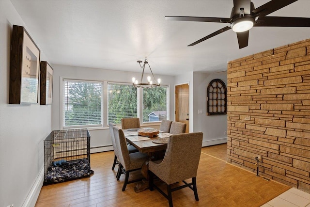 dining space with light hardwood / wood-style floors, a notable chandelier, and a baseboard heating unit