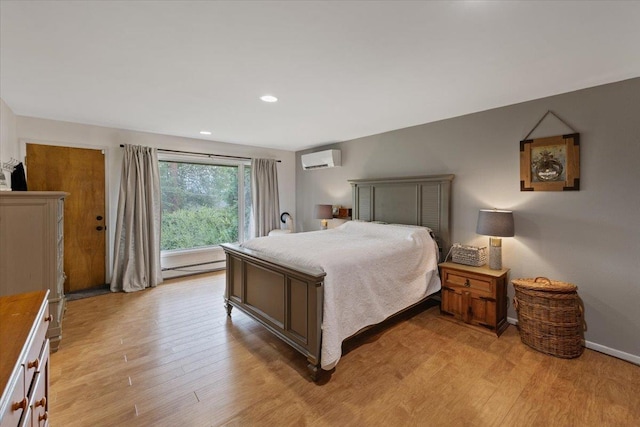 bedroom with an AC wall unit, a baseboard radiator, and light hardwood / wood-style flooring