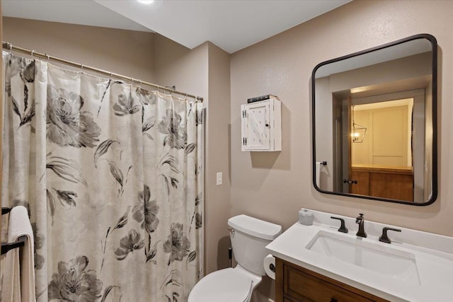 bathroom featuring curtained shower, toilet, and vanity