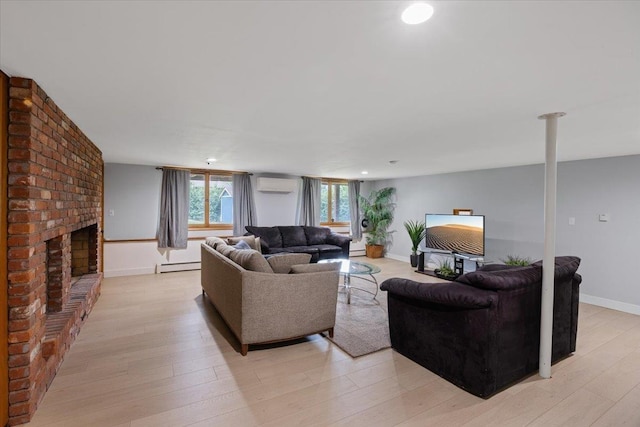 living room with light hardwood / wood-style floors, a baseboard radiator, a fireplace, and a wall unit AC