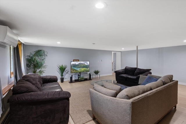 living room with light hardwood / wood-style floors and a wall unit AC