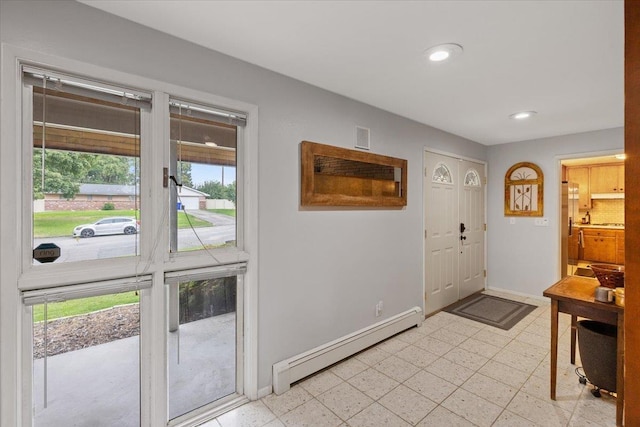 entryway with baseboard heating and a healthy amount of sunlight