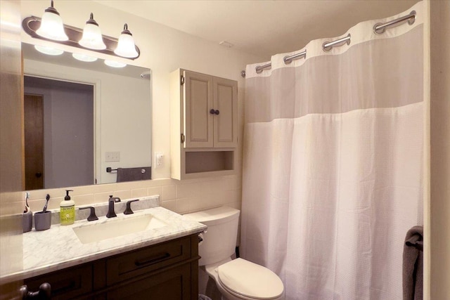 bathroom with vanity, toilet, decorative backsplash, and a shower with curtain