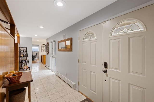 foyer entrance with plenty of natural light and a baseboard heating unit