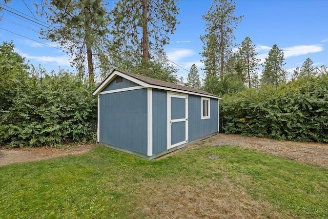 view of outbuilding featuring a yard