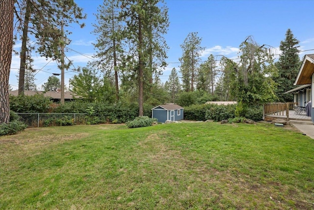 view of yard with a deck and a shed