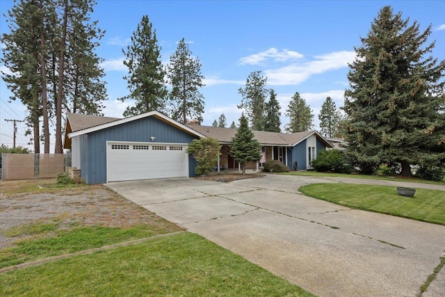 single story home featuring a garage and a front yard