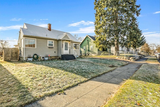 rear view of property with a lawn