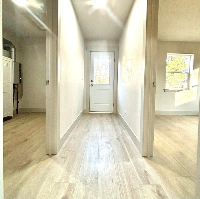 hallway with light hardwood / wood-style flooring