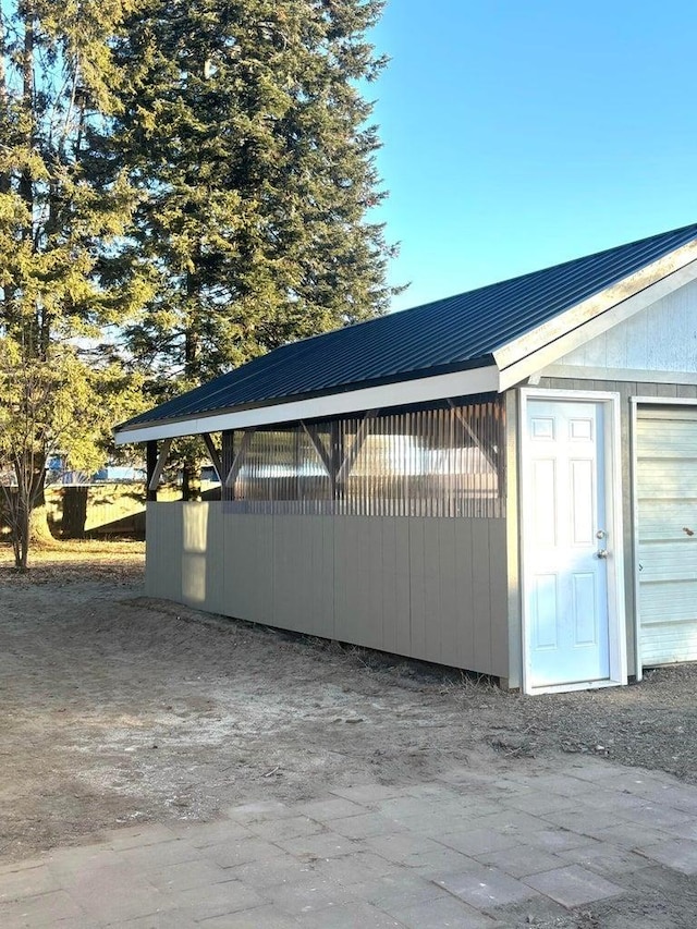 view of side of home featuring an outdoor structure