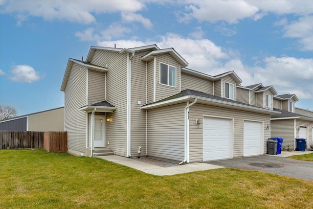 view of front of house with a garage and a front lawn