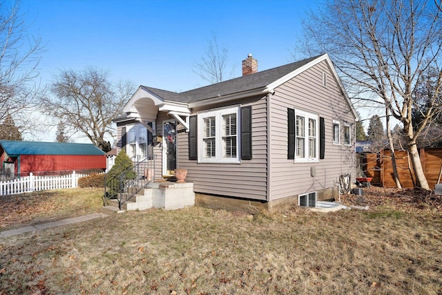 bungalow-style home with a front yard