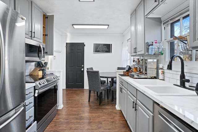 kitchen featuring appliances with stainless steel finishes, sink, and gray cabinetry