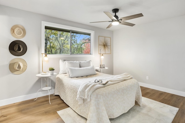 bedroom with ceiling fan and hardwood / wood-style flooring