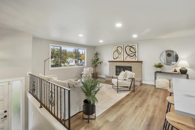 living room with light hardwood / wood-style floors and a fireplace