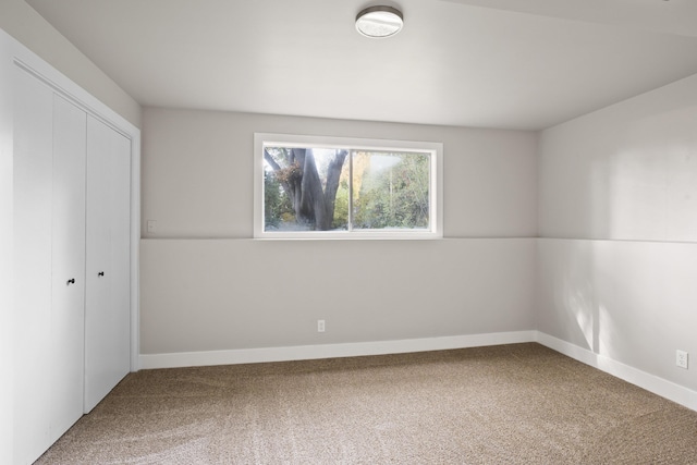 unfurnished bedroom with carpet floors and a closet