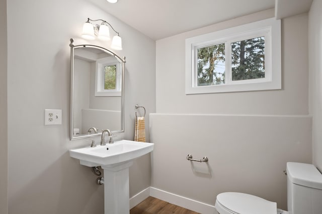 bathroom featuring wood-type flooring and toilet