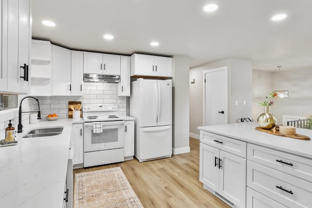 kitchen featuring white cabinetry, sink, white appliances, and pendant lighting