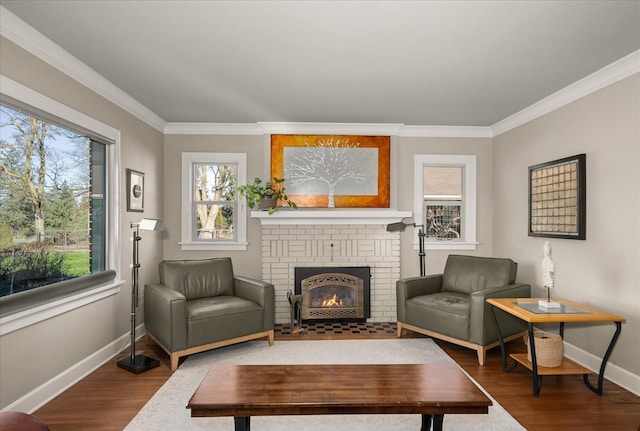 living area with wood-type flooring, a brick fireplace, and ornamental molding