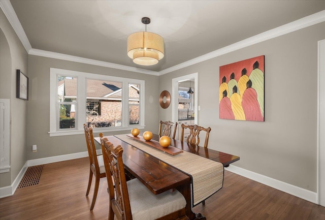 dining space featuring hardwood / wood-style flooring and ornamental molding