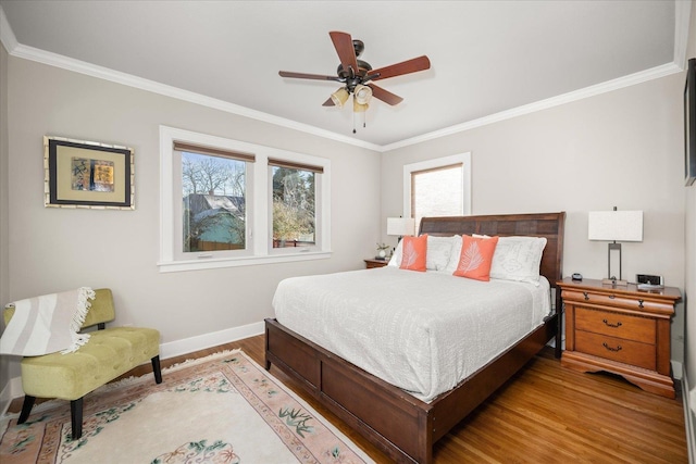 bedroom featuring ceiling fan, hardwood / wood-style floors, and crown molding