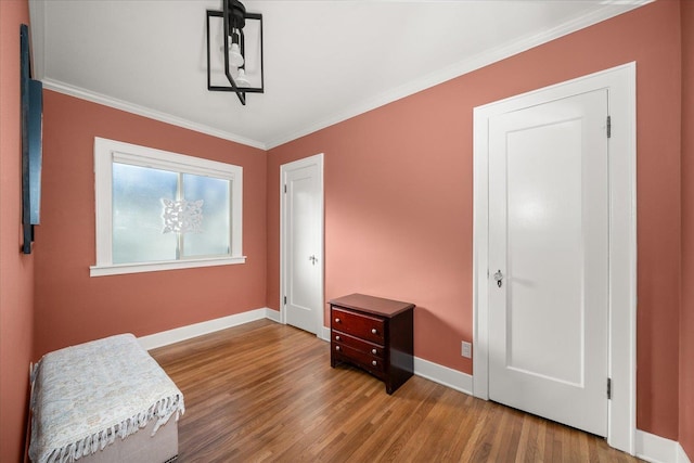 sitting room with hardwood / wood-style floors and ornamental molding