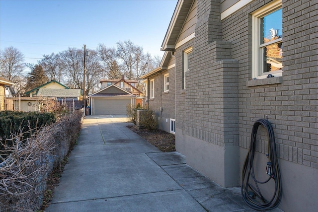 view of property exterior with a garage and an outbuilding