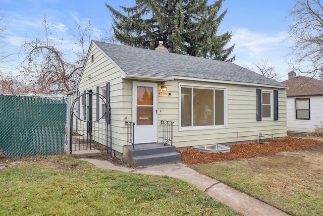 bungalow-style home with a front yard