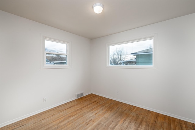 empty room with light hardwood / wood-style flooring