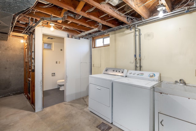 laundry area featuring washing machine and clothes dryer