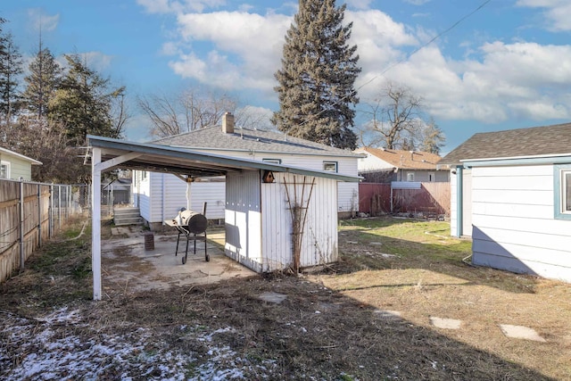 rear view of house featuring a patio and a storage unit