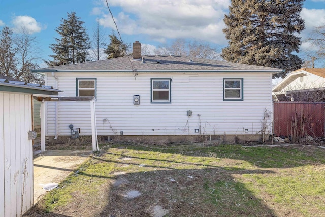 rear view of property featuring a yard