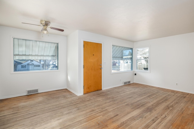 unfurnished room with light wood-type flooring and ceiling fan